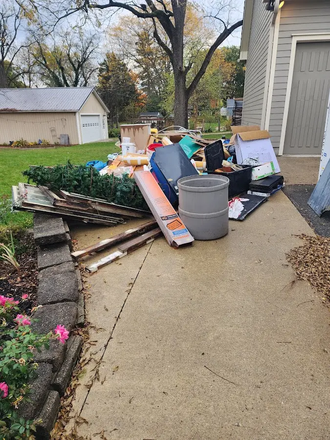 Dumpster being loaded with debris for Estate Cleanout Dumpster Rental in Prineville